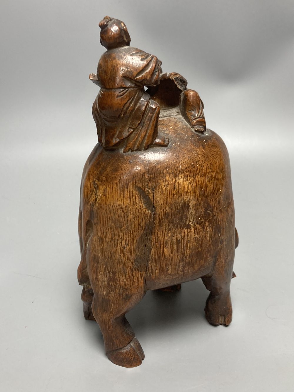 A Chinese bamboo group of figures on an ox and a wrist rest, 23 and 17cm
